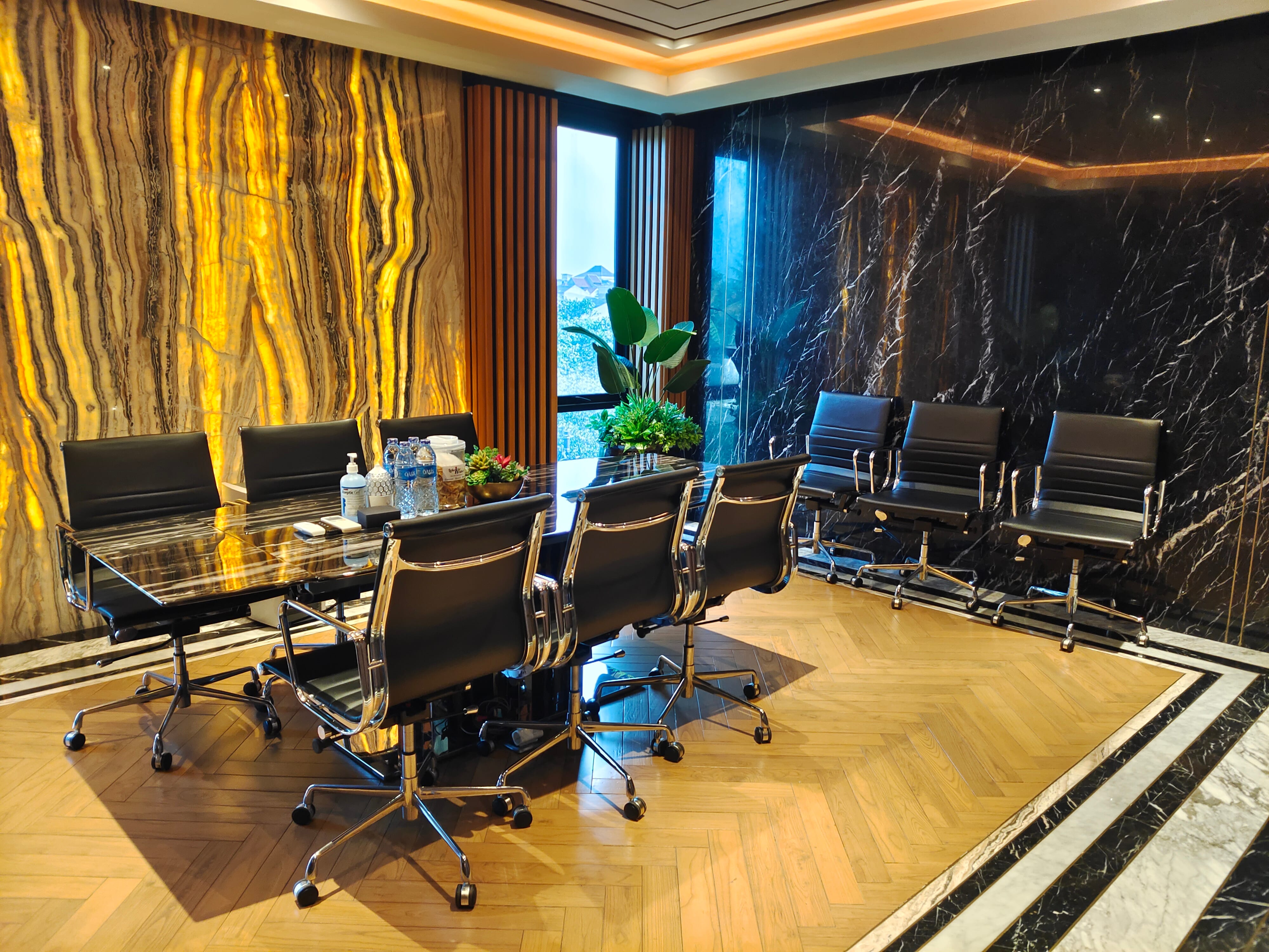 Boardroom with solid wood herringbone parquet flooring and vertical slat partition at Pusat Gadai by Reywood